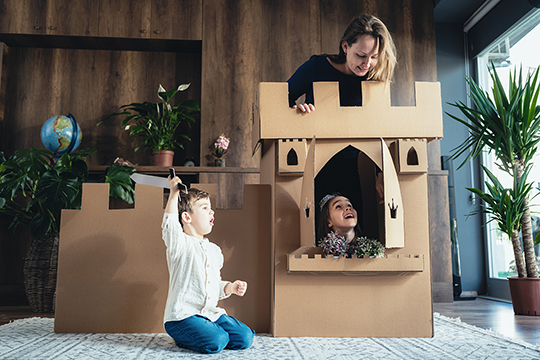 Mother and two children building forts.