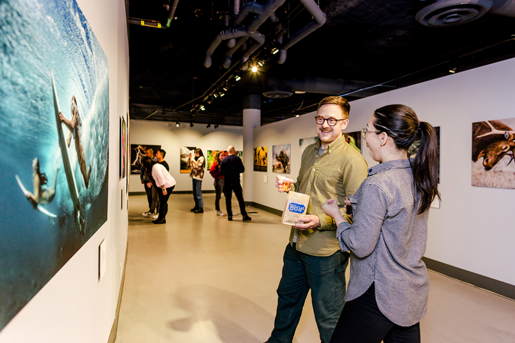 Visitors viewing underwater photography at Spectacle: Rare and Astonishing Photos